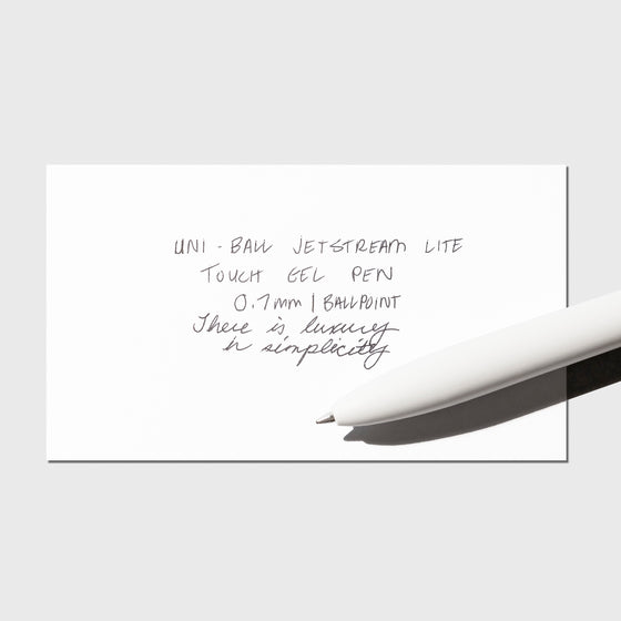 Image shows a pen test sheet of the Uni-ball Jetstream Lite Touch Gel Pen in Shell White.