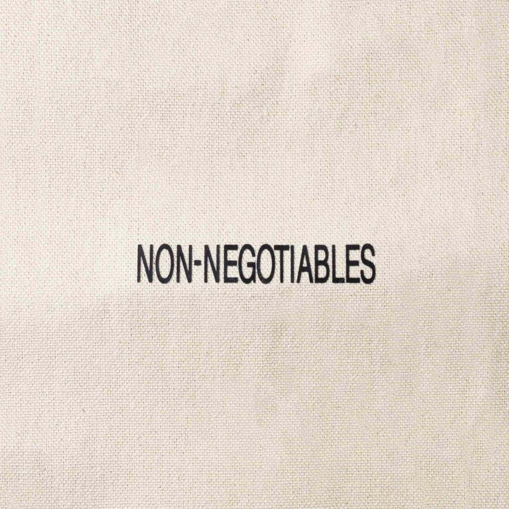 Close up of text on tote bag that reads "NON-NEGOTIABLES"