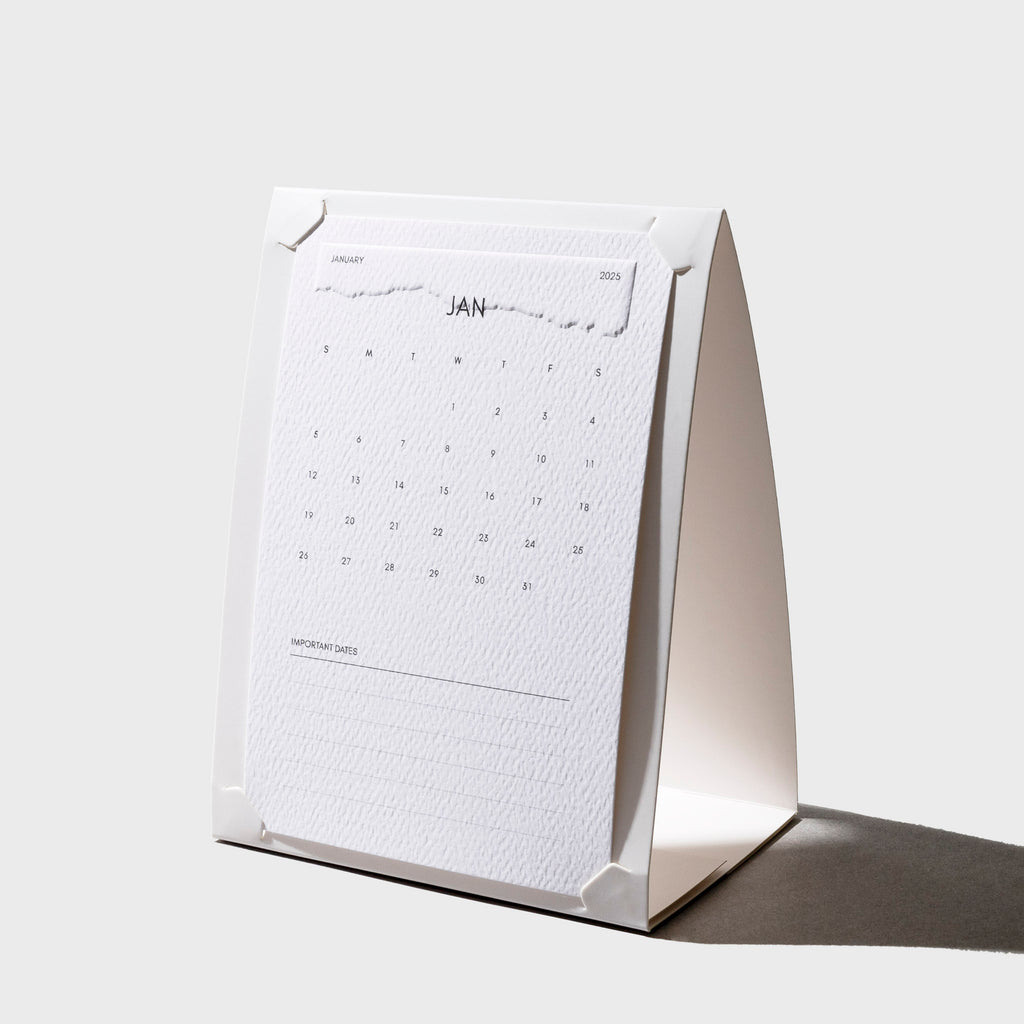 Paper Stand, Cloth and Paper. Stand shown with a 2025 calendar card fit inside of it on a neutral background.