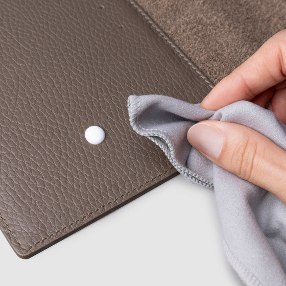 Conditioner in use inside a brown leather agenda.