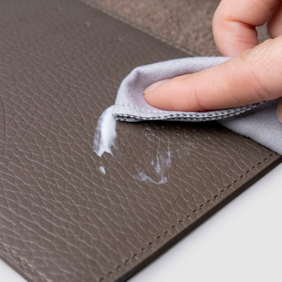 Conditioner in use inside a brown leather agenda.