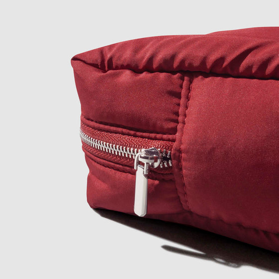 Closeup of silver zipper hardware on quilted pouch.