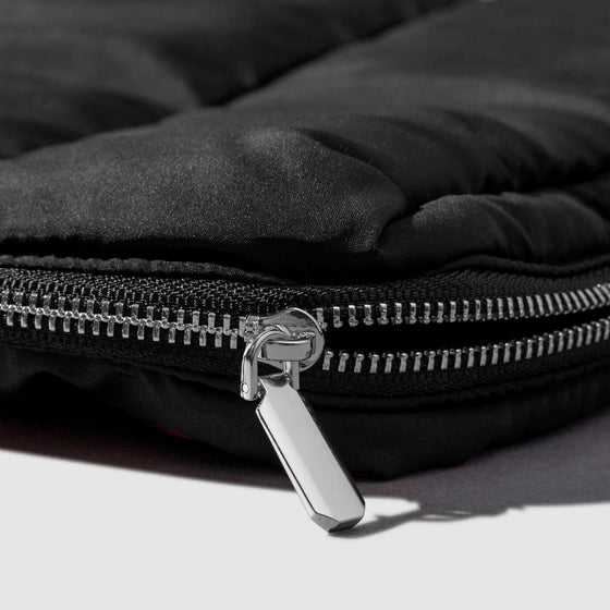 Closeup of silver zipper hardware on pouch. Color shown is Avant Garde.