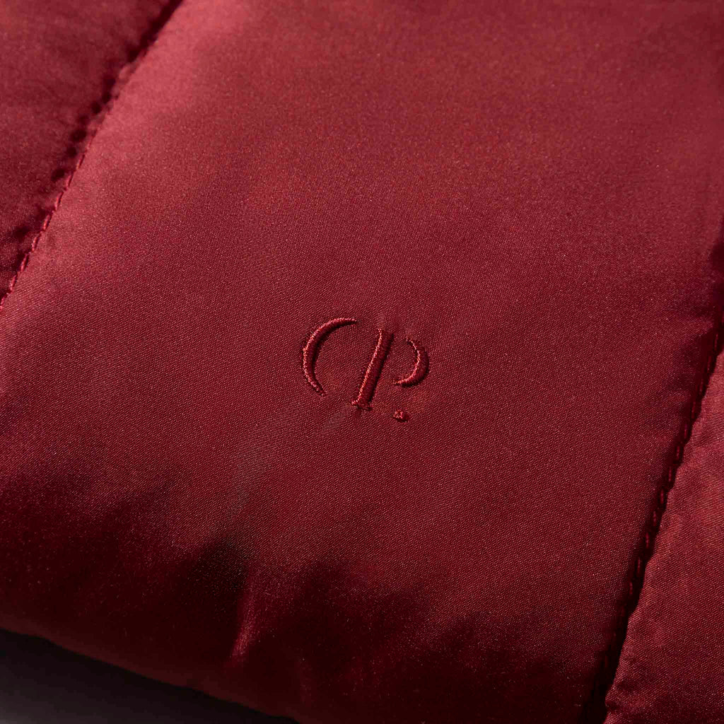 Closeup of Cloth and Paper logo on pouch. Color shown is Merlot.