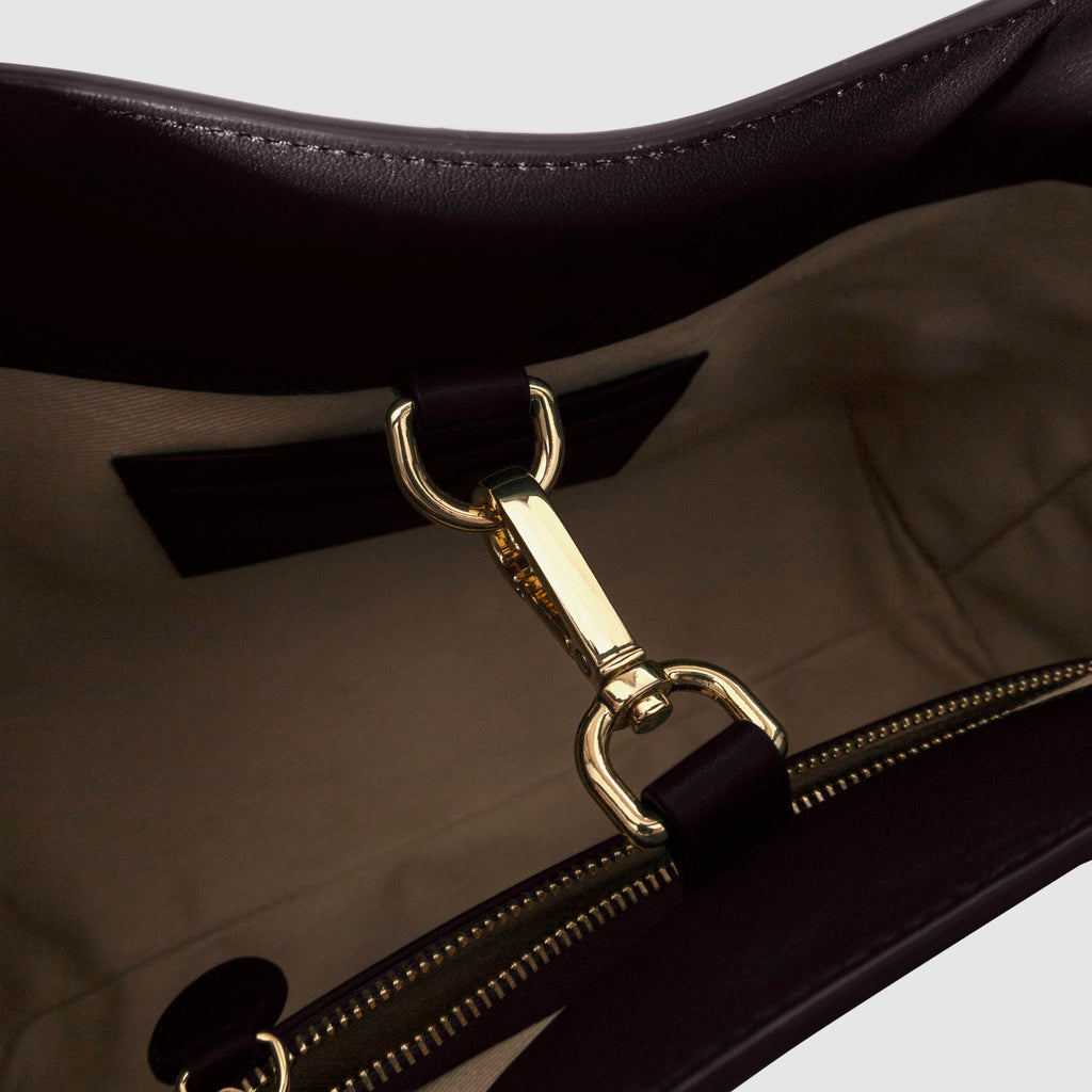 Top down view of bag showcasing its gold hardware. It secures the bag shut. Color shown is Madrid.