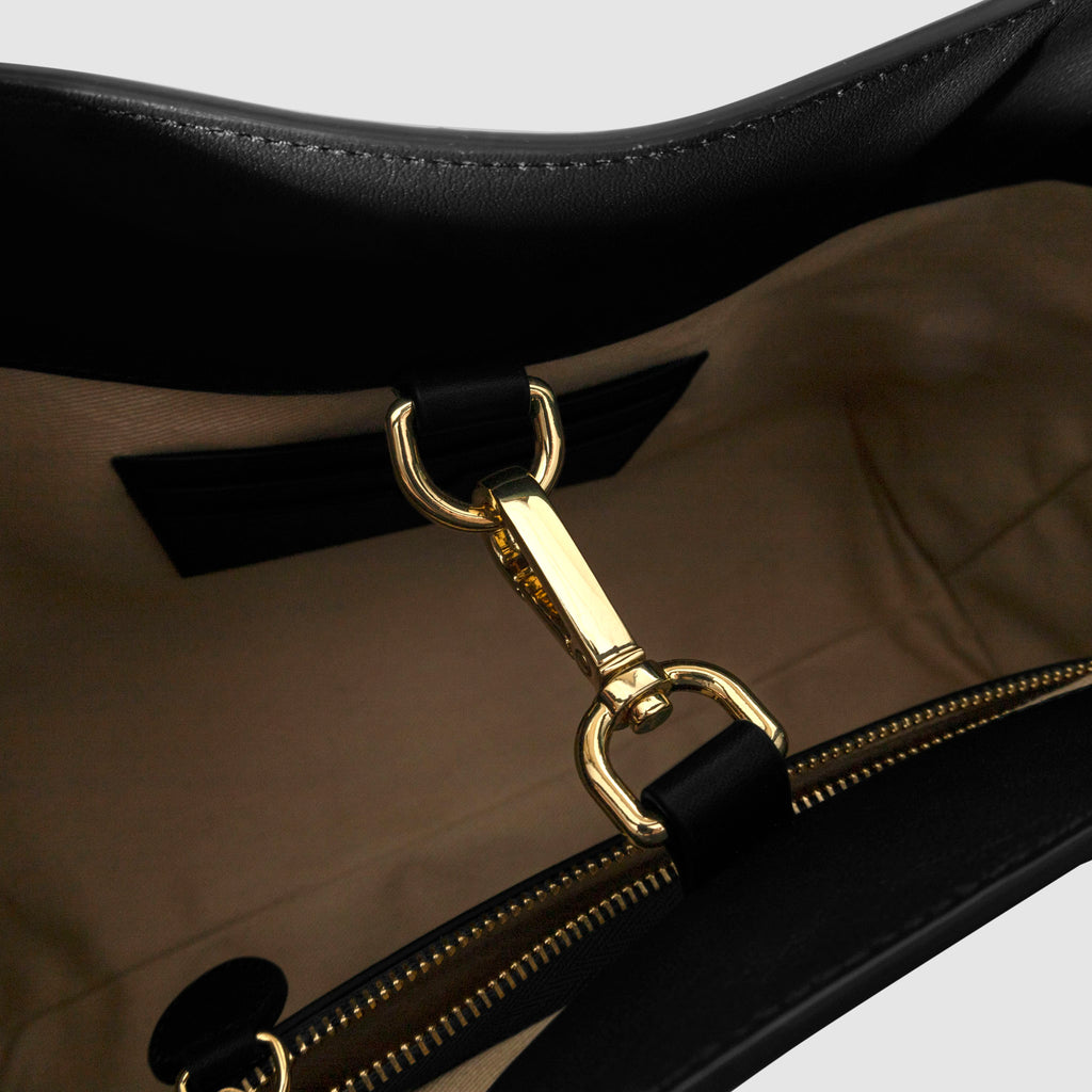 Top down view of bag showcasing its gold hardware. It secures the bag shut. Color shown is Padrillo.