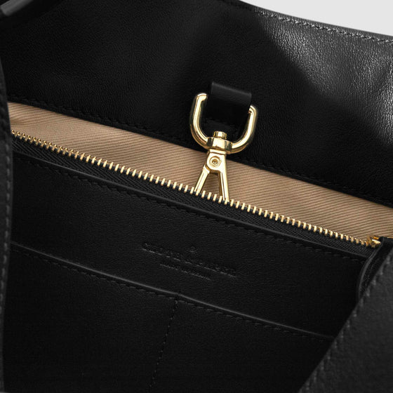 Top down view of bag showcasing its gold hardware. It secures the bag shut. Color shown is Padrillo.