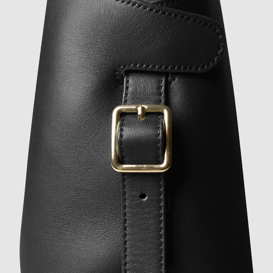 Side view of bag showcasing its gold hardware and adjustable leather strap. Color shown is Padrillo.