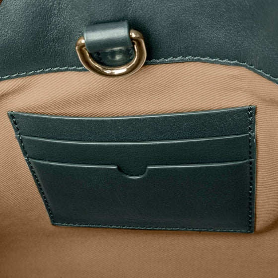 Closeup of credit card slots inside bag. Color shown is Salamanca.