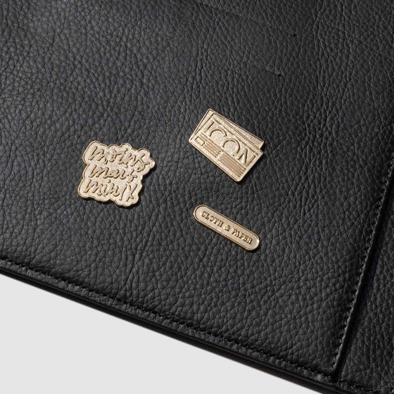 Set of 3 pins displayed in a black leather agenda.