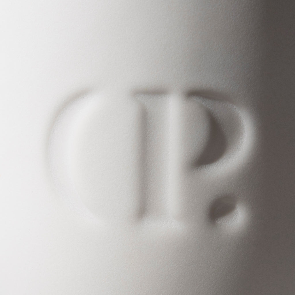 Closeup of embossed Cloth and Paper logo on the mug.