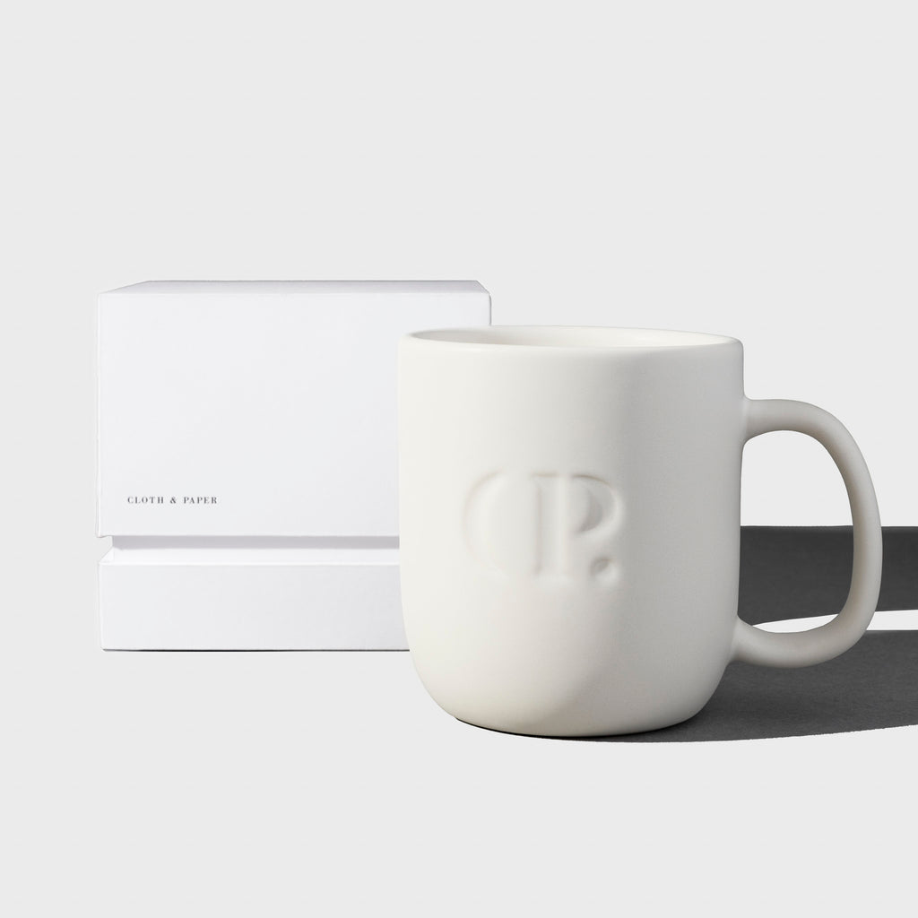 Mug shown with its packaging on a neutral background.