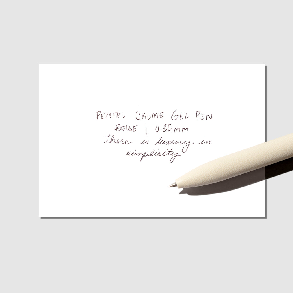 Pen displayed with a pen testing sheet on a neutral background.