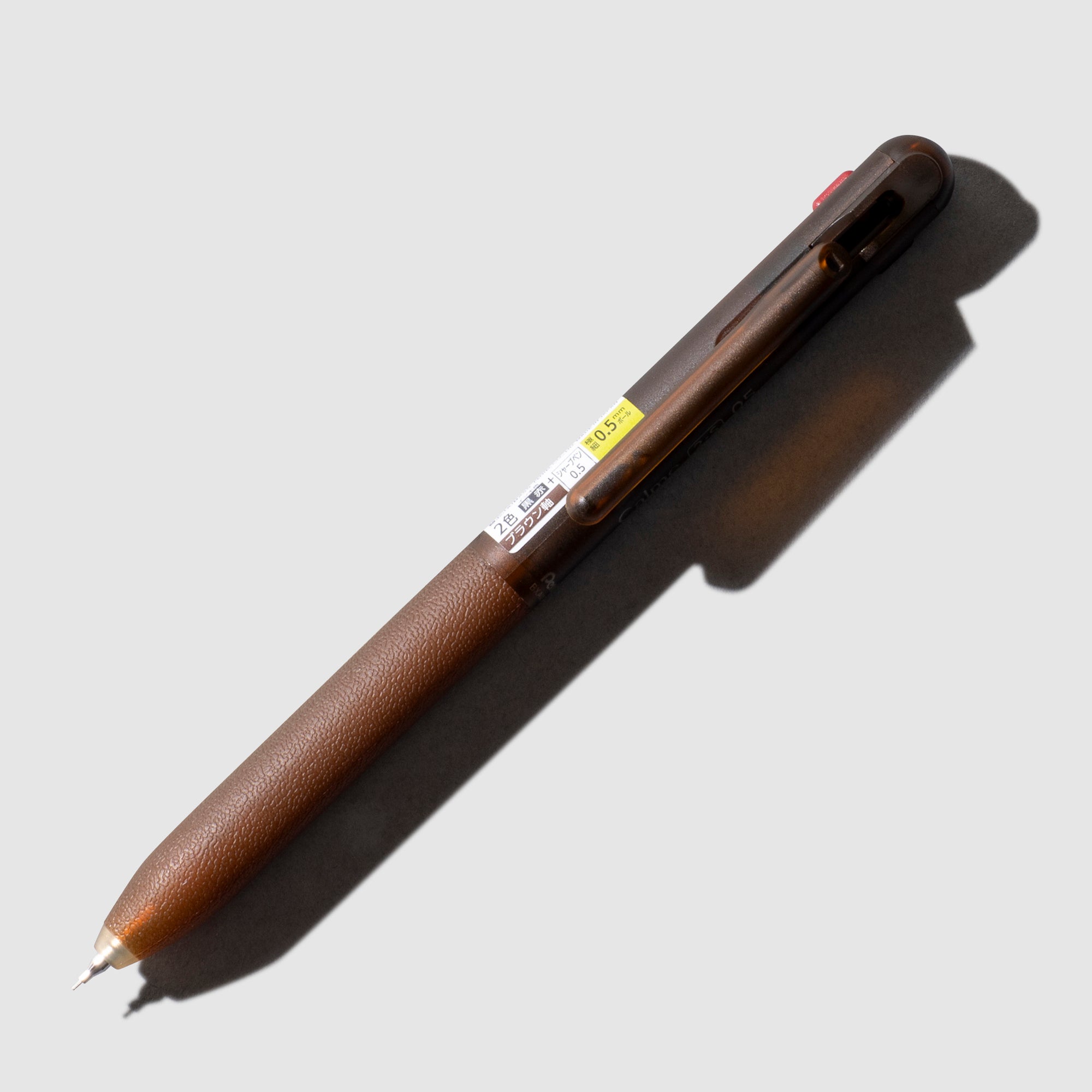 Pentel Calme Multifunction Ballpoint Pen, Cloth and Paper. Brown pen shown on a neutral background.