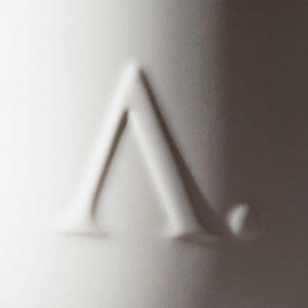 Closeup of Aesthete logo embossed on mug.