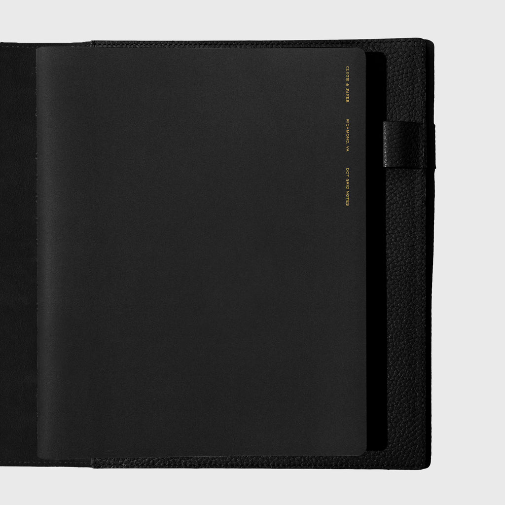 Notebook shown closed inside a black leather agenda. Color shown is Avant Garde.