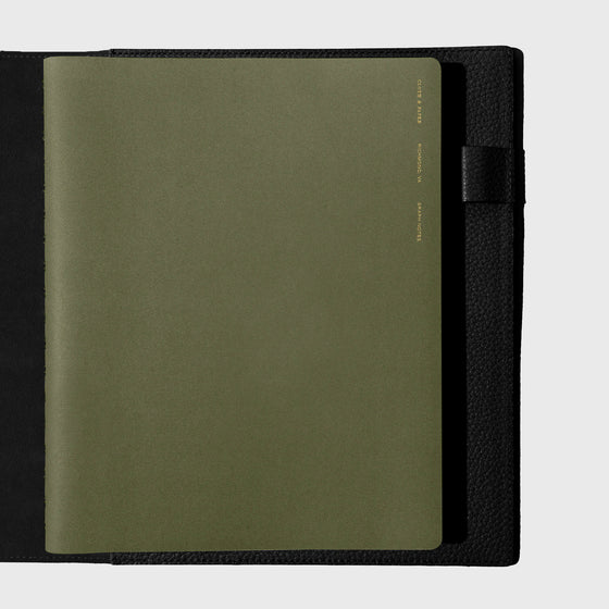 Notebook shown closed inside a black leather agenda. Color shown is Olive.