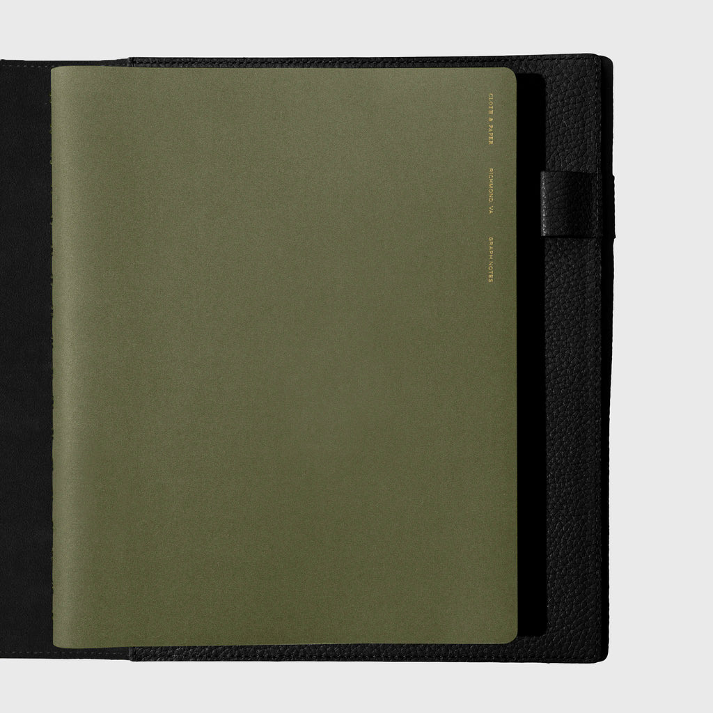 Notebook shown closed inside a black leather agenda. Color shown is Olive.