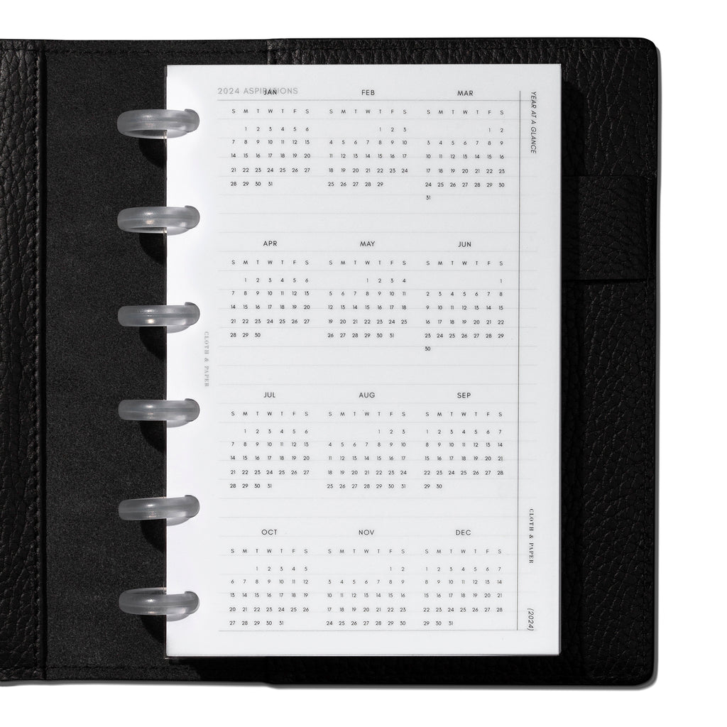CP Petite  dashboard shown in use inside a black leather planner.