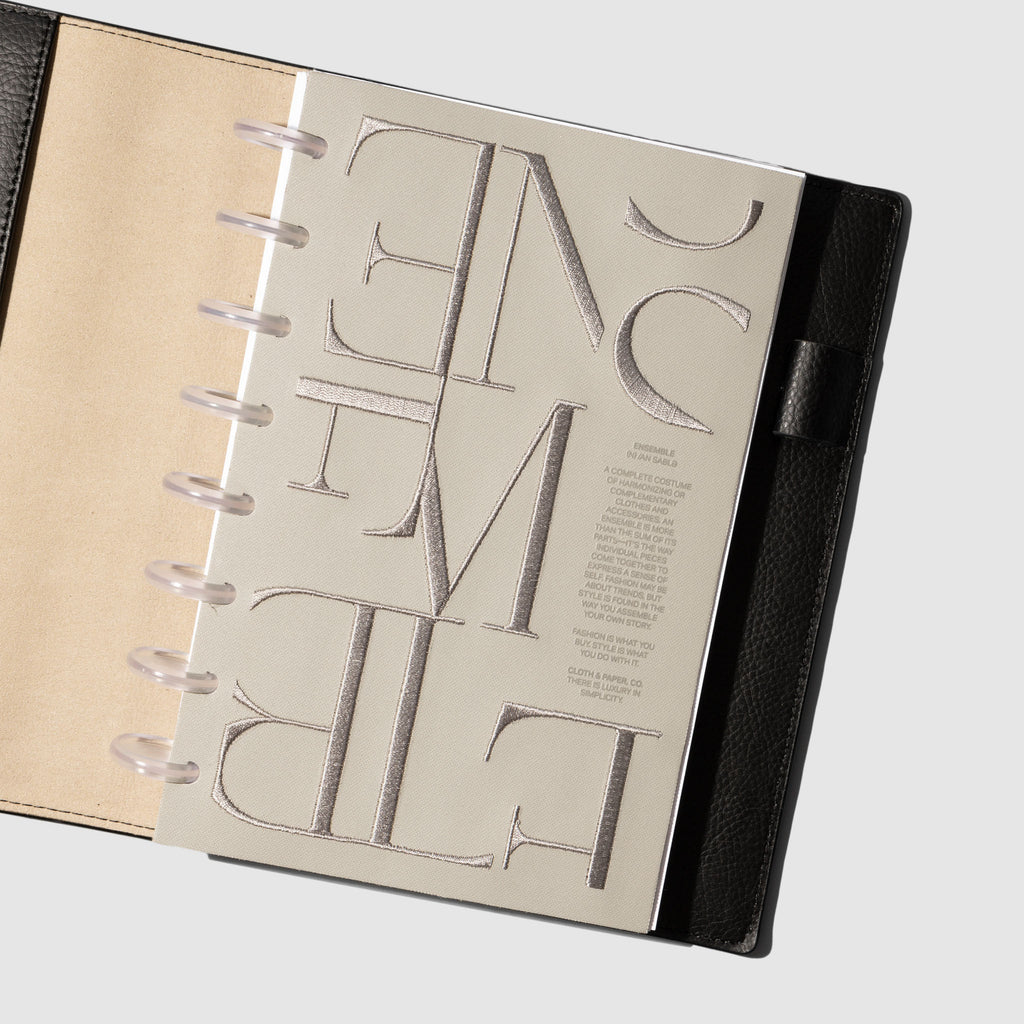 Dashboard displayed in a leather planner on a neutral background. Size shown is Half Letter.