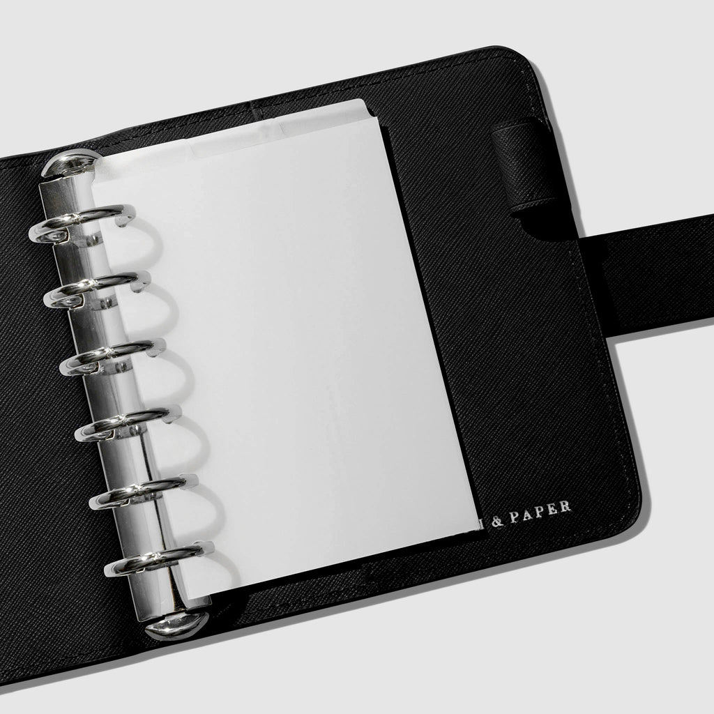 Dividers in use inside a black leather agenda.