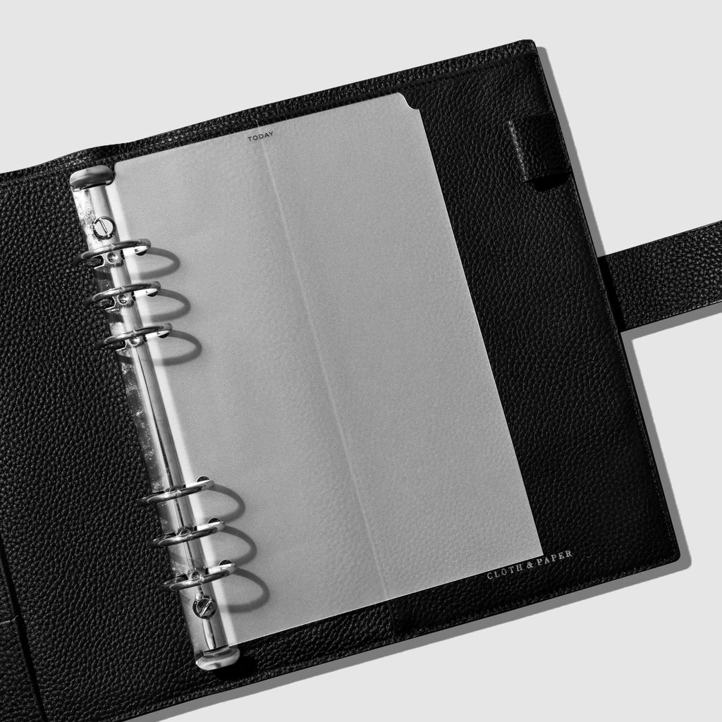 Divider in use inside a black leather planner.