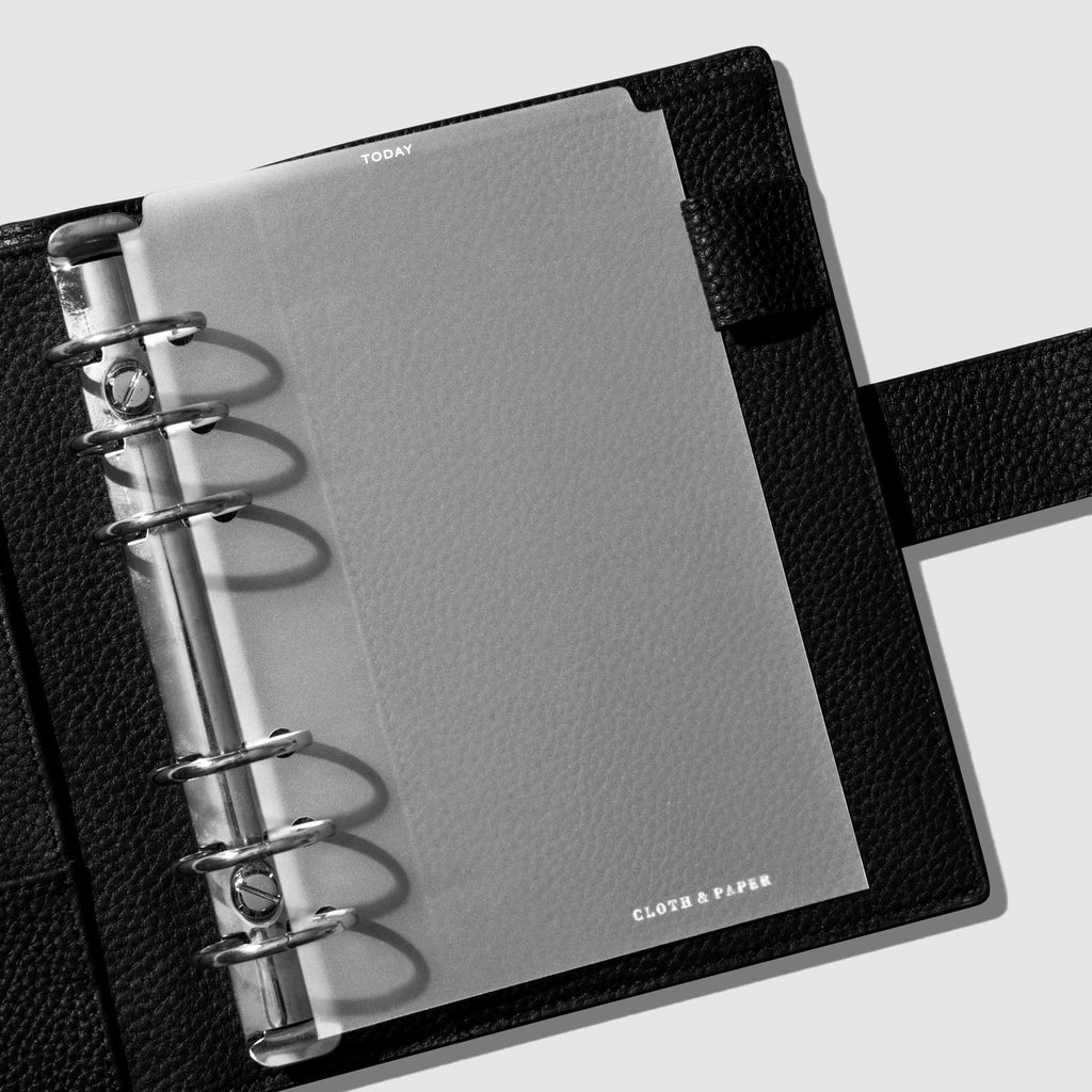 Divider in use inside a black leather planner.