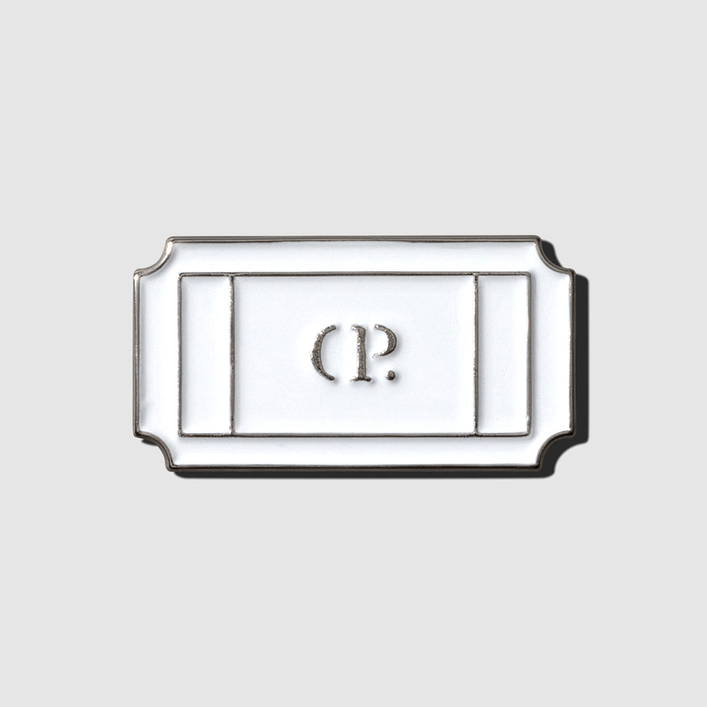 Ticket enamel pin displayed on a neutral background.