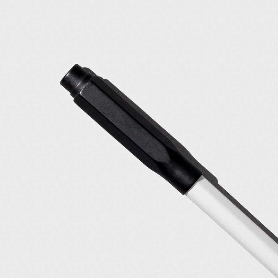 The image shows the blackwing point guard in matte black covering the sharpened tip of a white pencil.