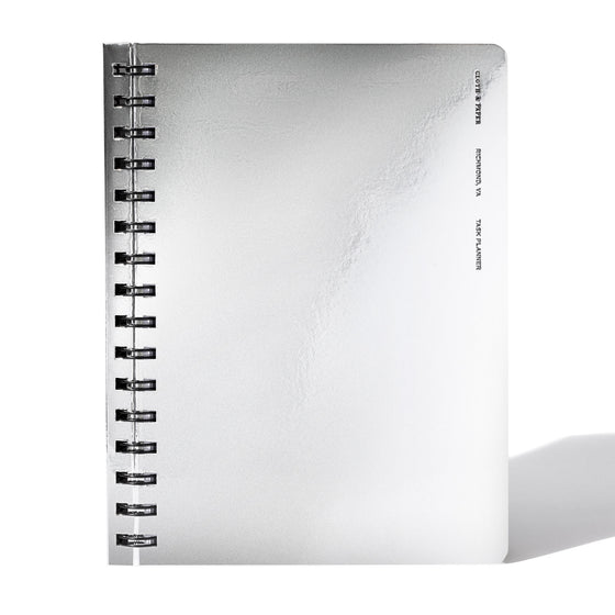 Silver notebook displayed on a white background.