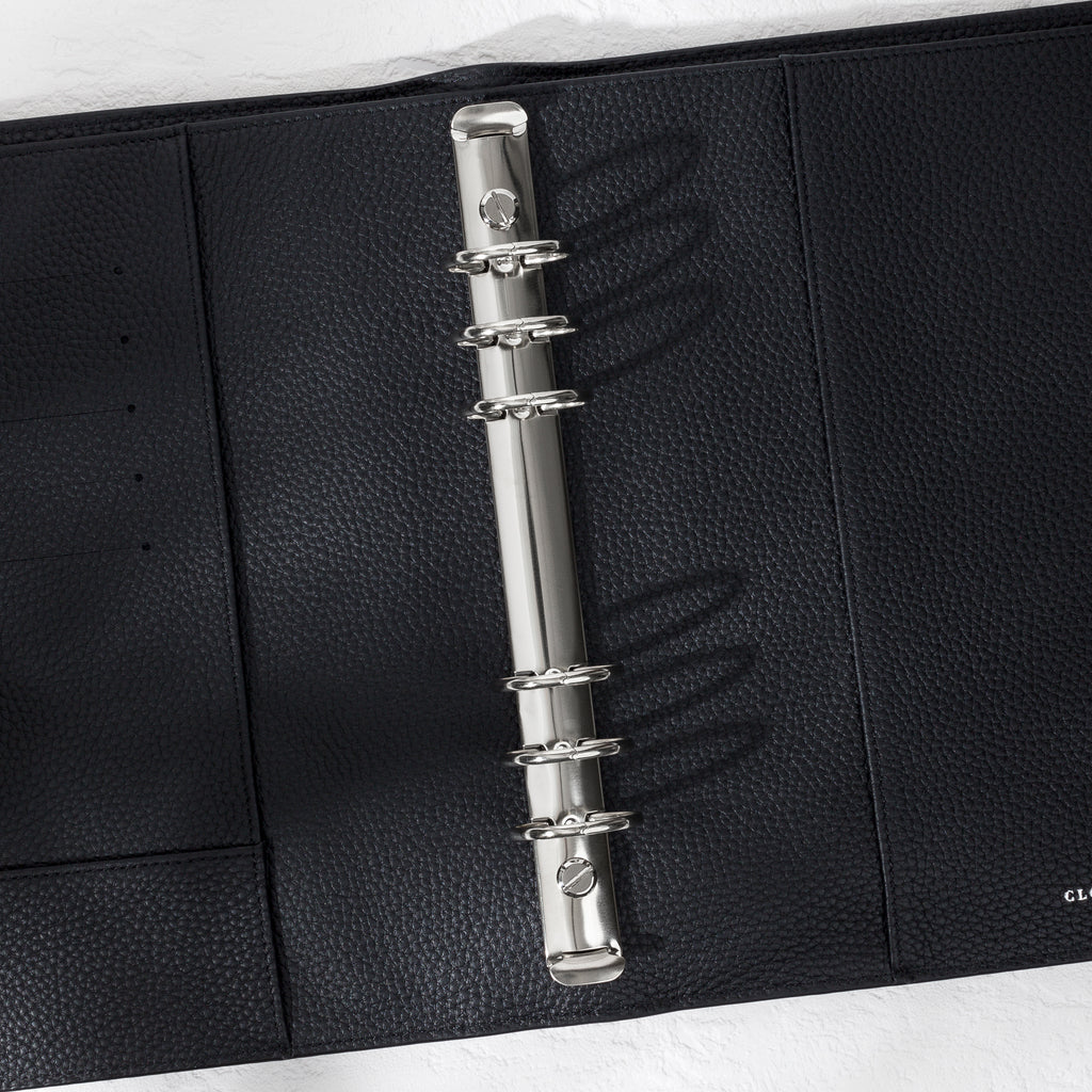 Closeup of silver hardware in a black leather agenda.