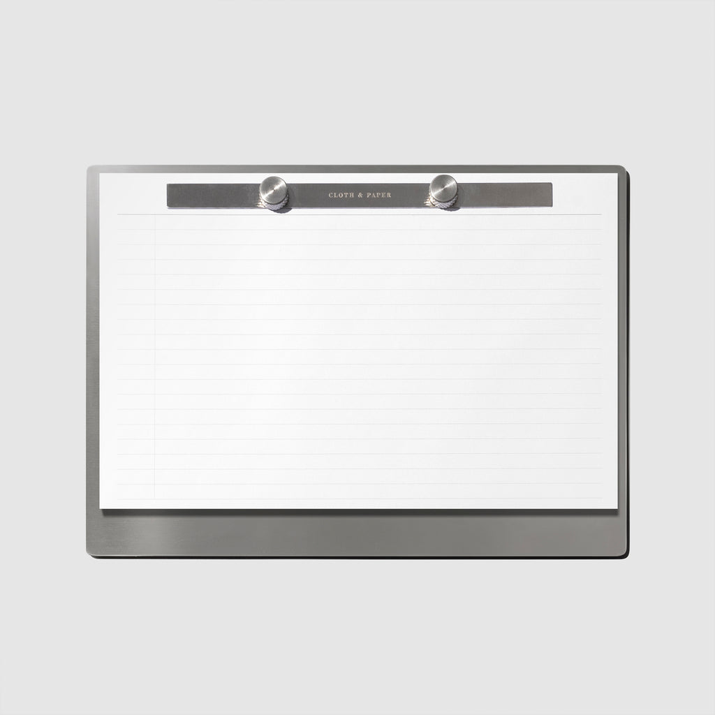 Modern Bound Notepad Insert Refills, lined, filled on the Modern Bound Notepad board, resting on a light gray background