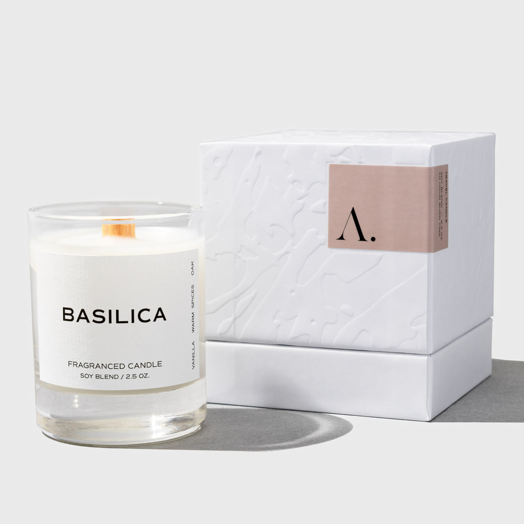 Image shows the Basilica travel candle next to an embossed box.