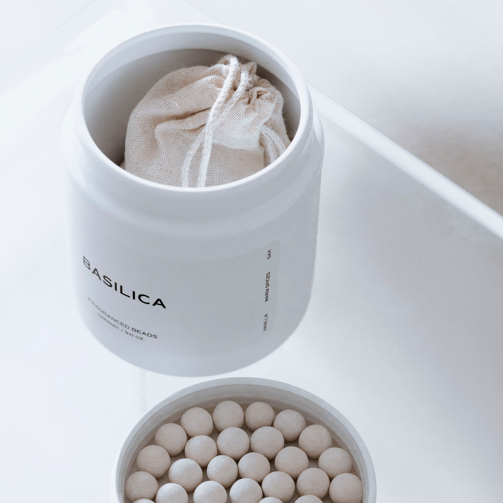 A container of Basilica Fragrance Drawer Bead Set is opened and some of the beads have been placed within the opened lid.