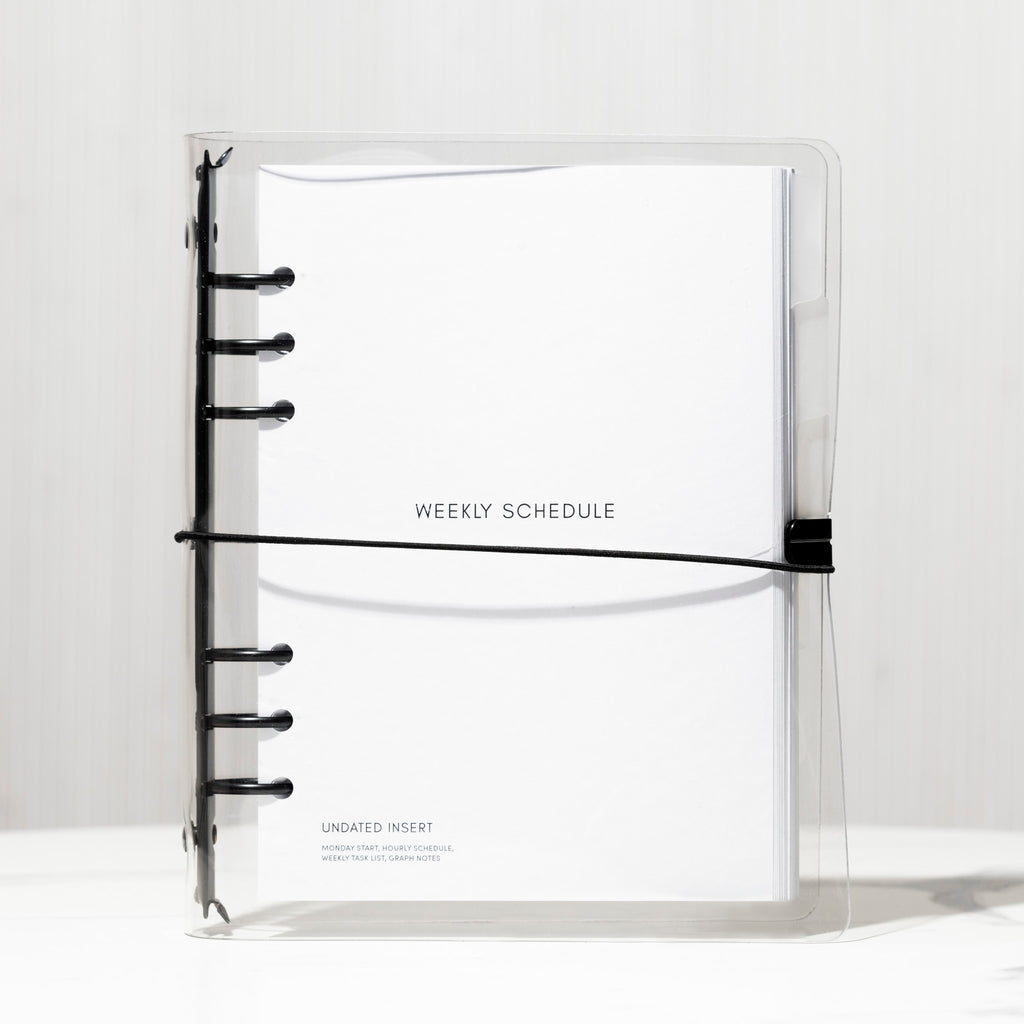 Beginner Planner Bundle in A5, assembled in the Clear Vinyl Cover, resting on a white background with shadows.