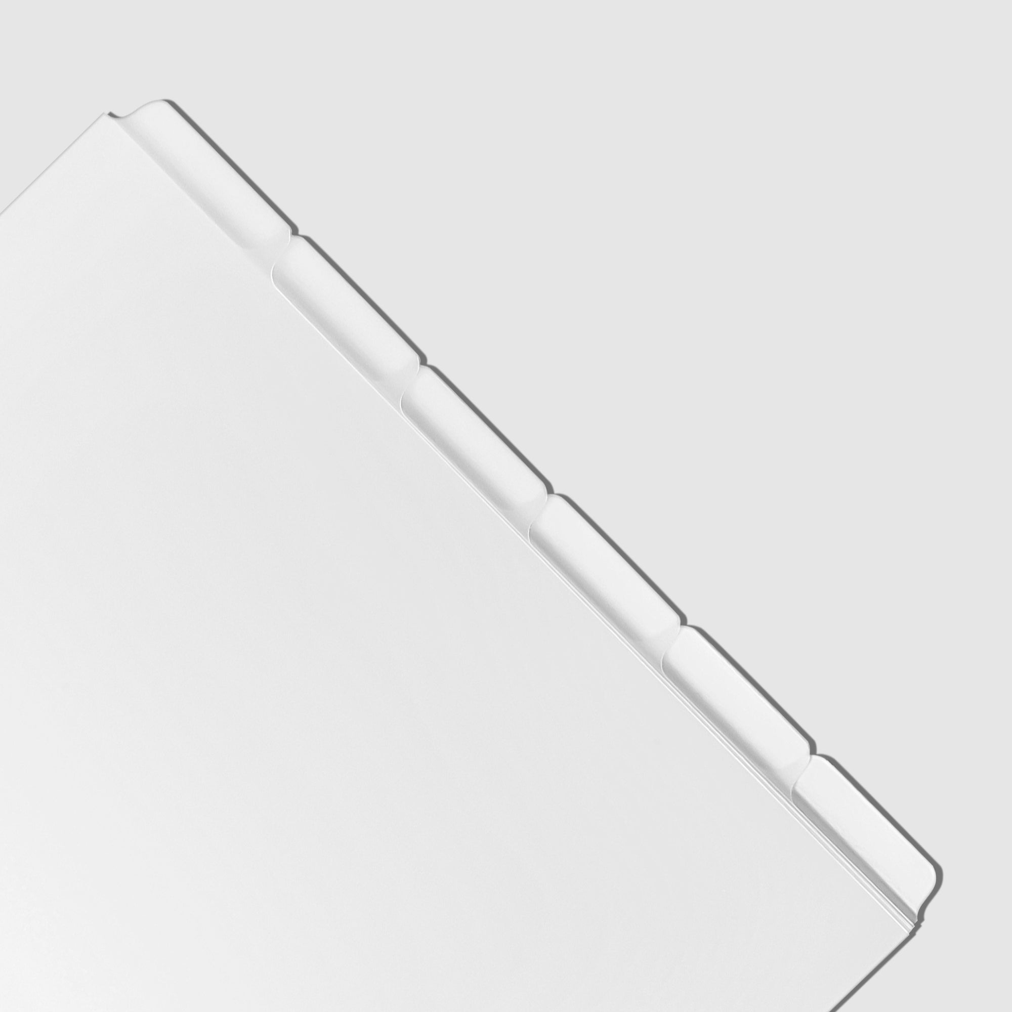 Closeup of blank divider tabs on a white background.