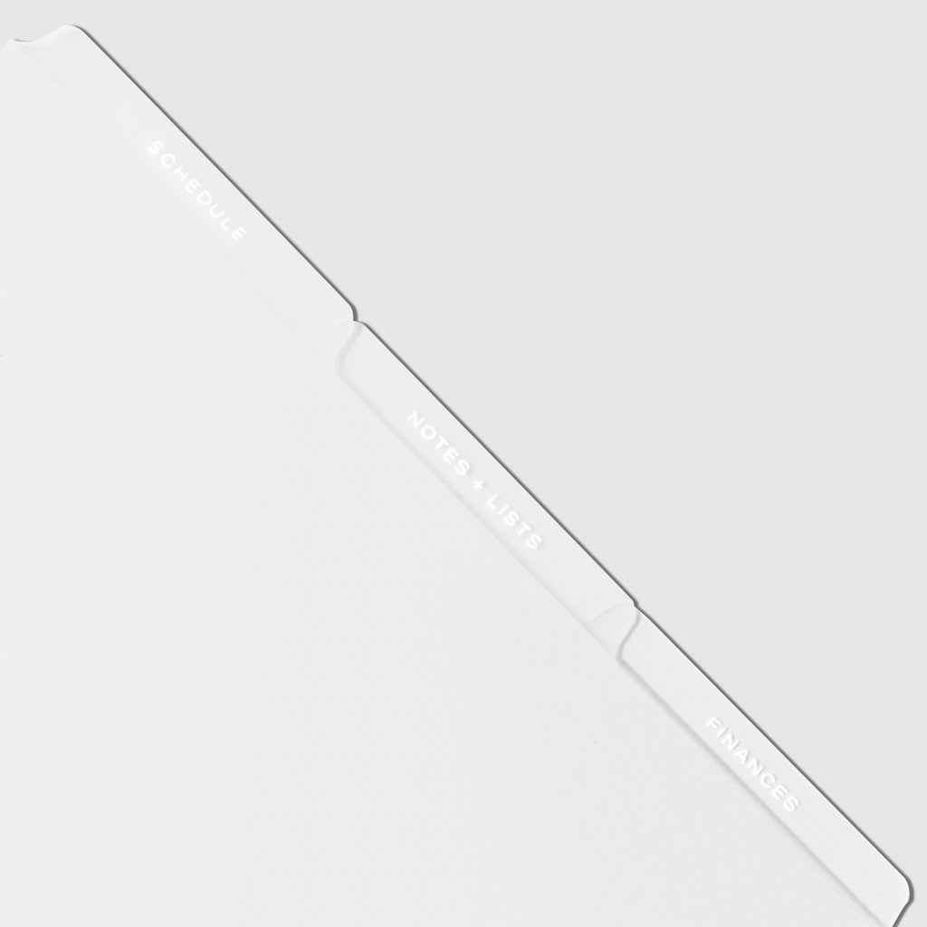 Closeup of white tab dividers displayed on a white background.