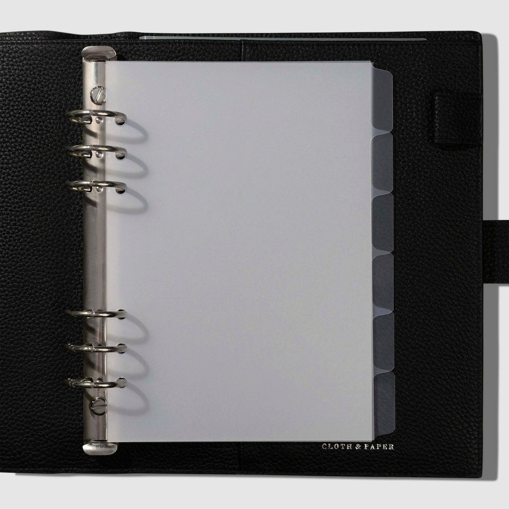 Dividers in use inside a black leather planner. 
