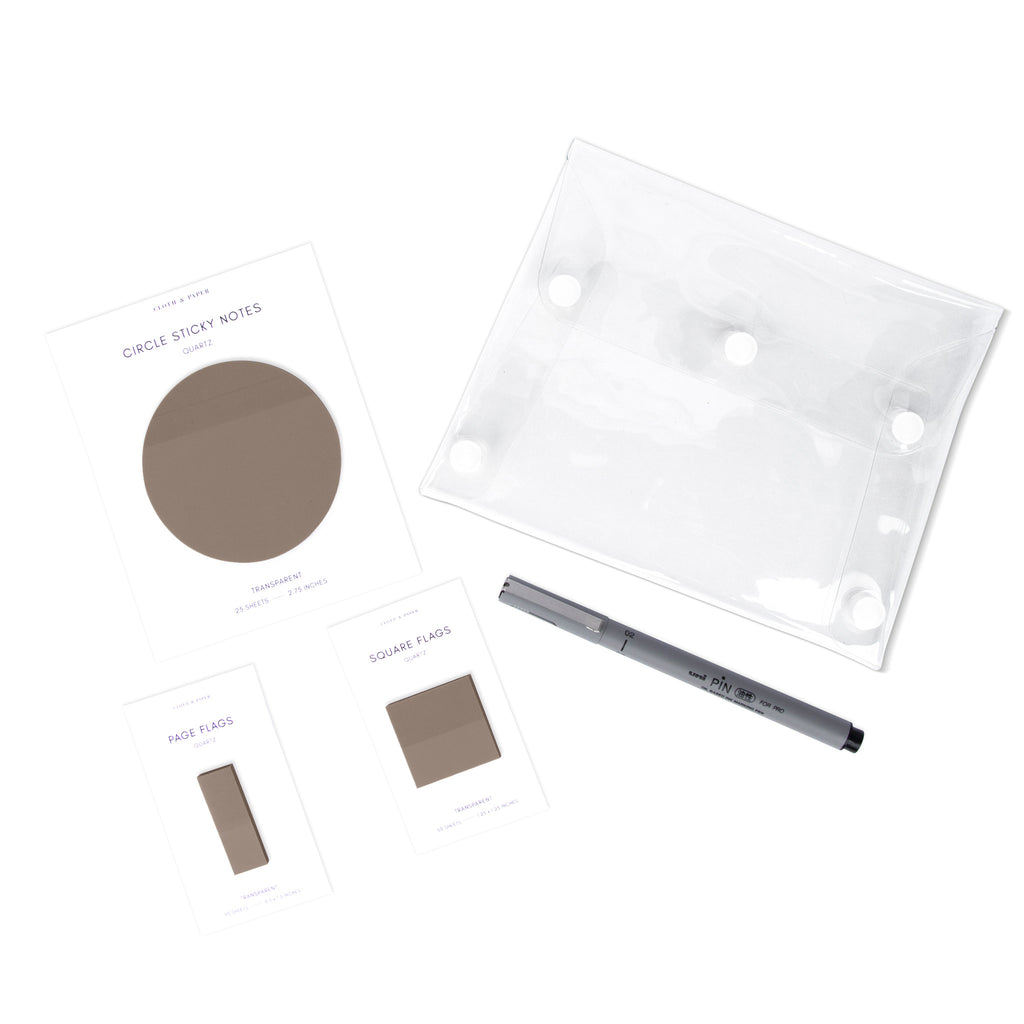 Matching set of circle sticky notes, page flags, and square page flags positioned next to a Uni Pin Marking Pen and Essentials Clear pouch. Sticky note color is Quartz.