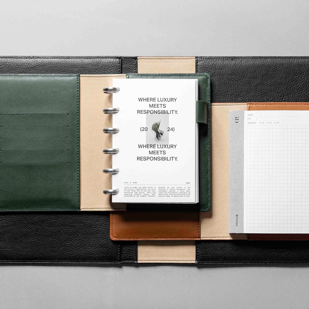 Collection of vegan leather folios displayed on a neutral background. A green folio is the centerpiece, displaying a Responsibility dashboard inside of it.