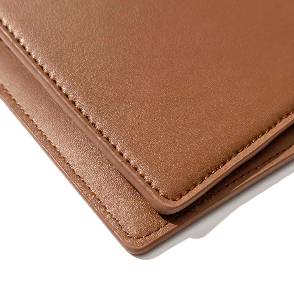Closeup of clay brown folio's smooth vegan leather.