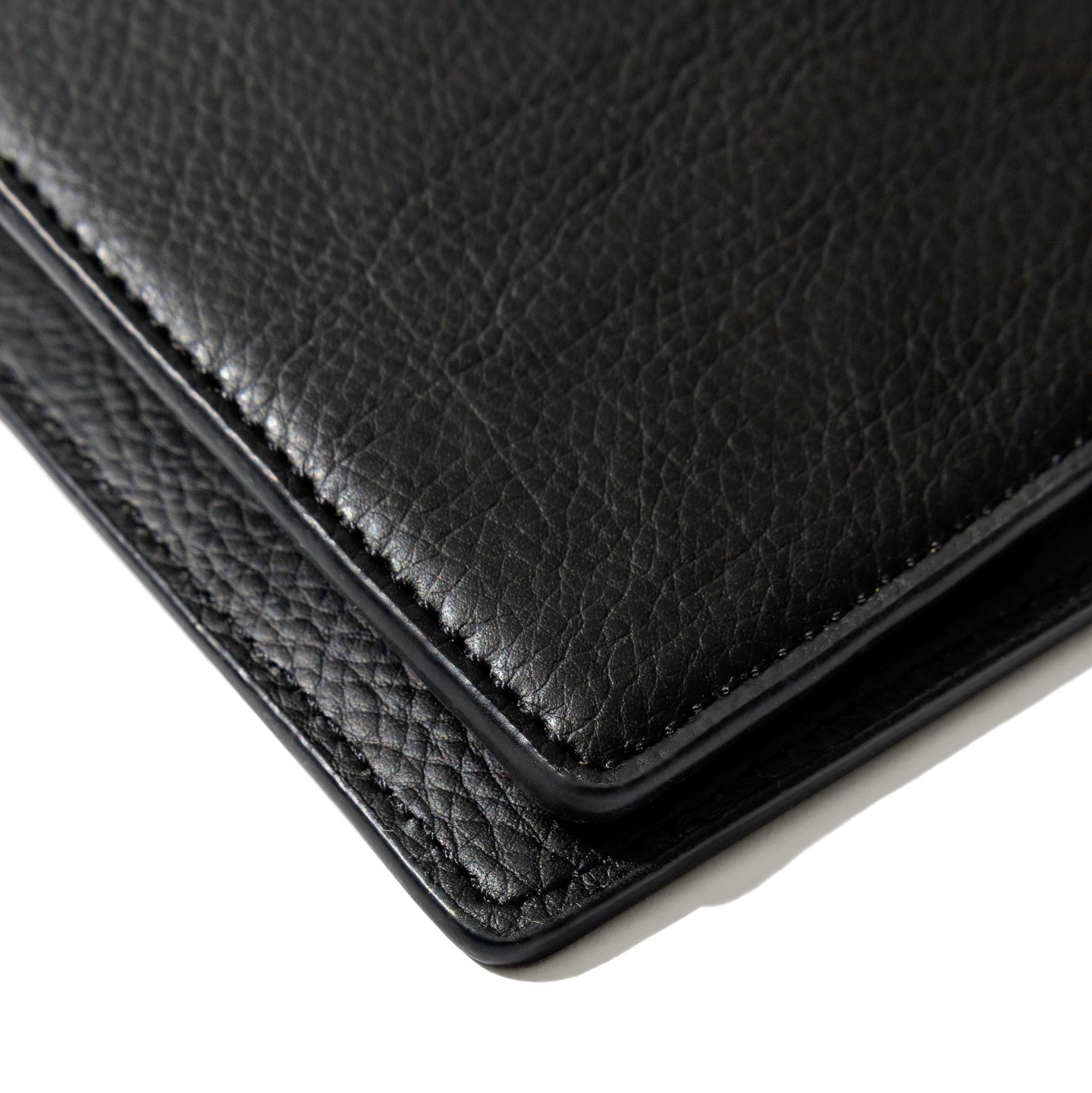 Closeup of mesa black folio's textured vegan leather.