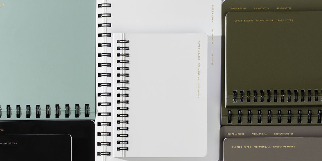 an image representing a variety of cover colors and page styles for our España Notebooks.  Featured here are the Cornell Notes in Mykonos, Dot Grid in Avant Garde, Lined in Ash, Graph in Olive, and Executive Notes in Cafe Noir.