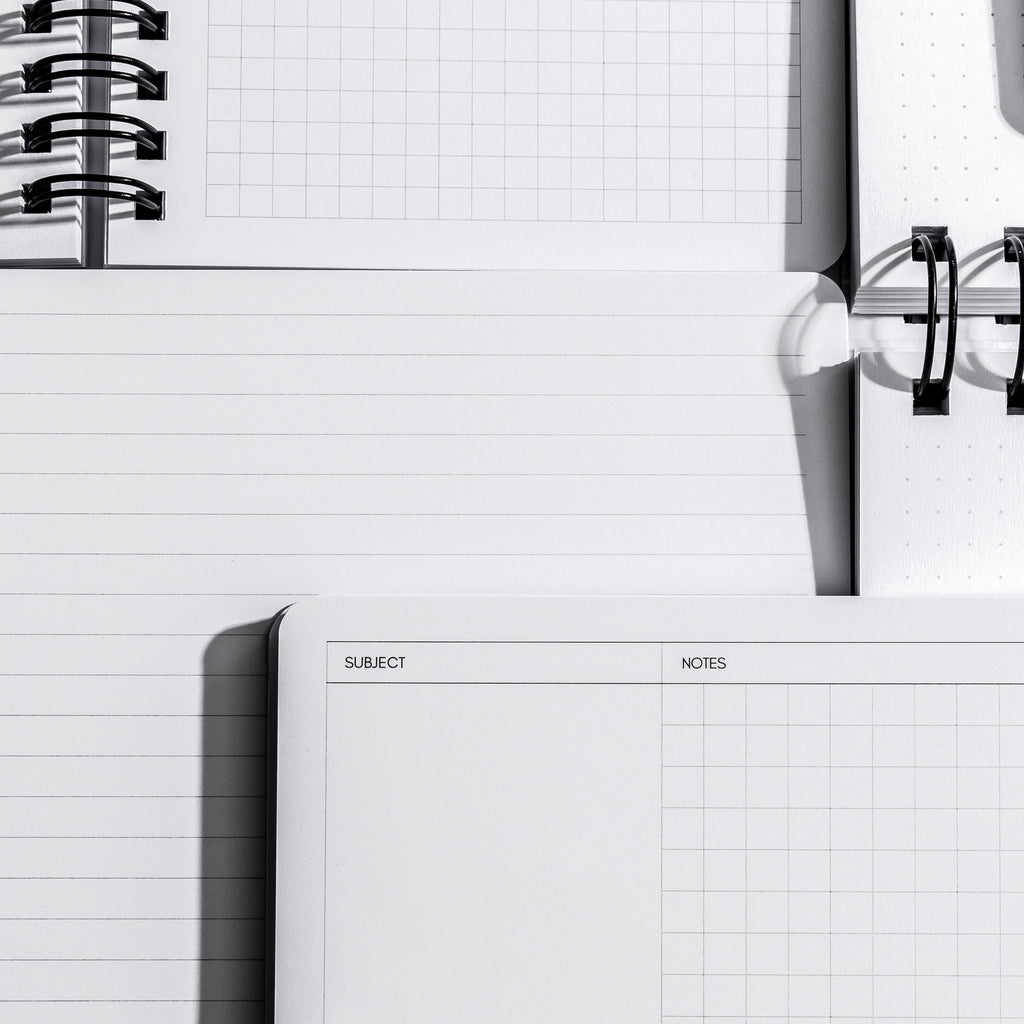 an image representing a variety of page styles and fields found in opened España Notebooks.  Featured here are the Graph, Lined, and Cornell Notes Notebooks.  The Cornell Notes has fields for subject and notes.