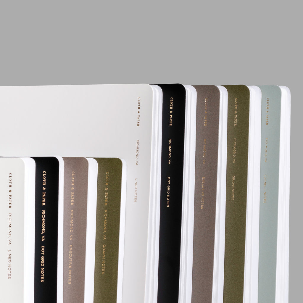 an image representing the different colors and styles available for our España Spiral Notebooks.  In order are Ash, Avant Garde, Cafe Noir, Olive, and Mykonos.  