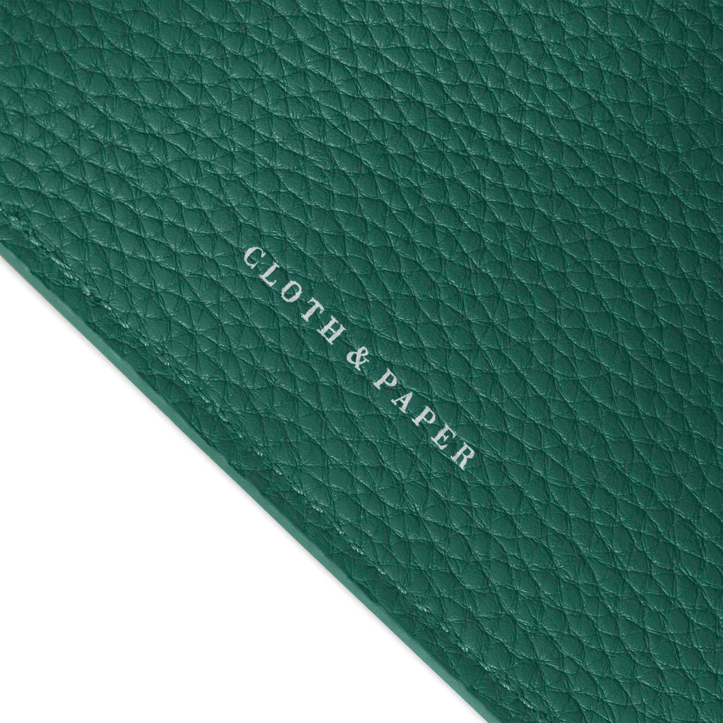 Closeup of Cloth and Paper logo on leather agenda.