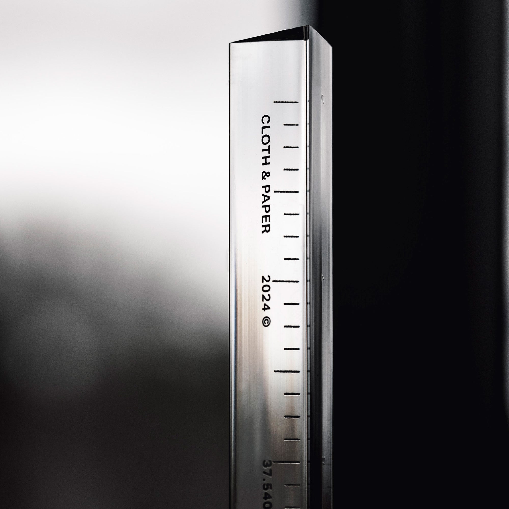 A sleek acrylic ruler with clear markings, displaying the "CLOTH & PAPER" logo and the year "2024".