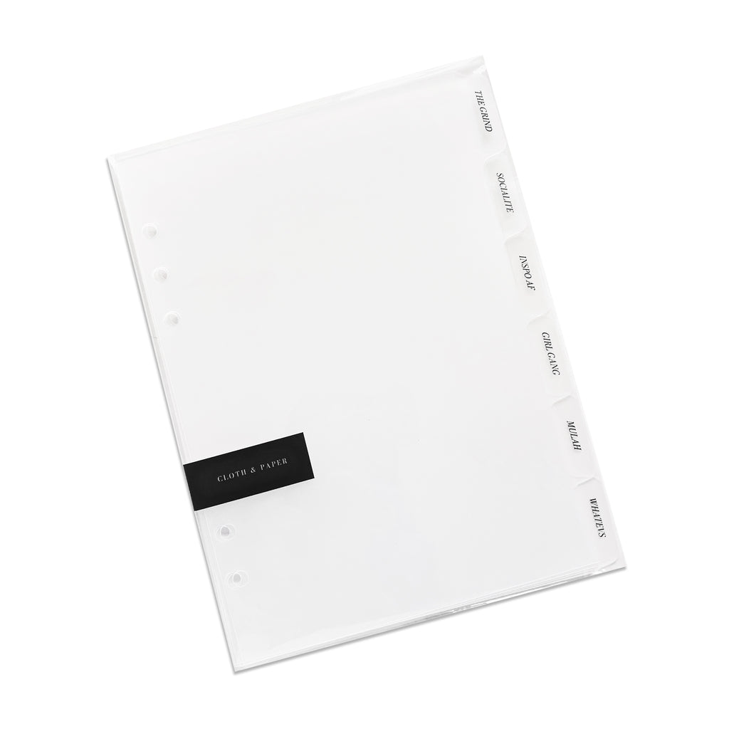 Girl Gang Side Tab Planner Dividers, Glass Plastic, Black Foil, Cloth and Paper. Dividers in their packaging tilted to the left on a white background.