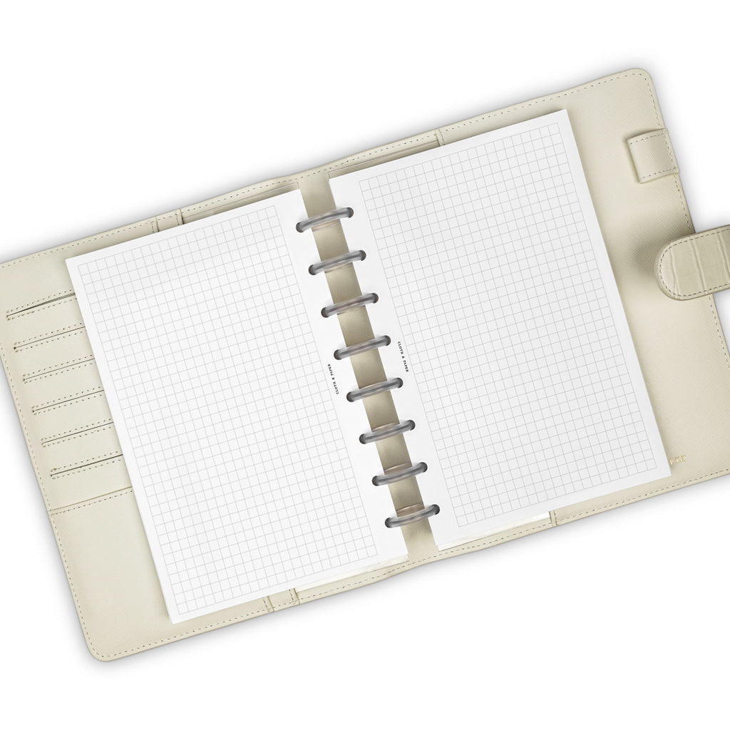 Graph Note Planner Insert, Cloth and Paper. Inserts in use inside a white leather agenda.