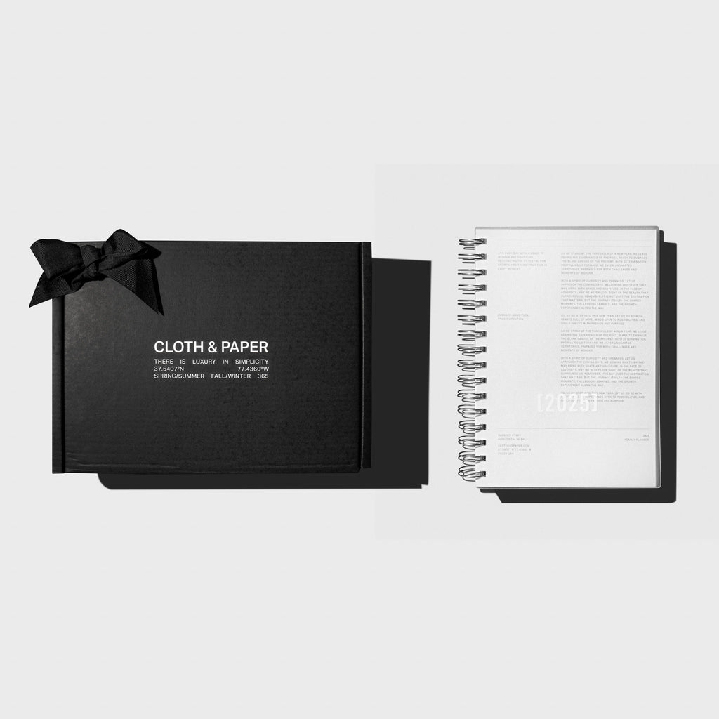 2025 Spiral Bound Planner, Single Purchase Subscription Box, Cloth and Paper. Box displayed with notebook on a neutral background.